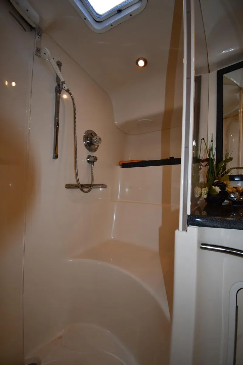 Slide: The Image of Shower area in 1997 Sea Ray 400 Sundancer yacht, featuring modern fixtures and lighting. - 37