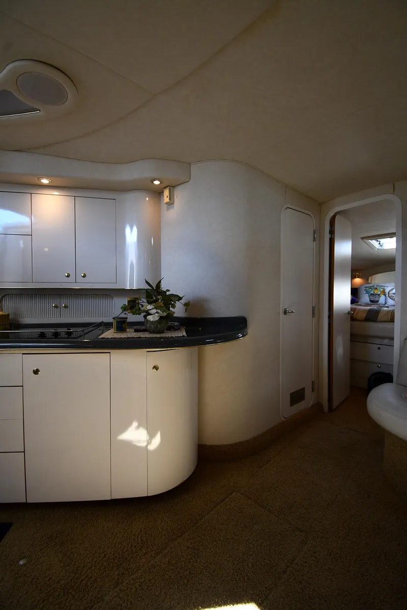 Slide: The Image of Interior of 1997 Sea Ray 400 Sundancer yacht with modern kitchen and cozy cabin. - 40