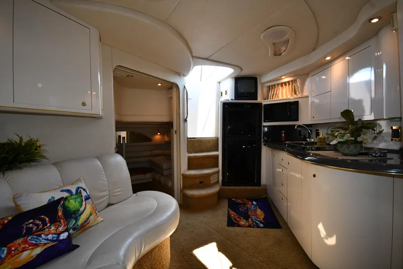 Slide: The Image of Interior of 1997 Sea Ray 400 Sundancer yacht with modern kitchen and seating area. - 43