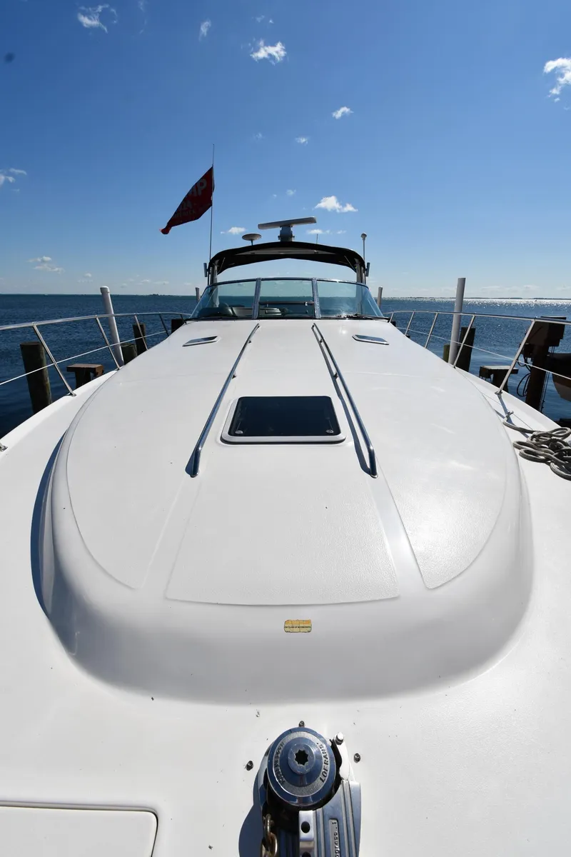 Slide: The Image of 1997 Sea Ray 400 Sundancer yacht docked under clear blue sky. - 5