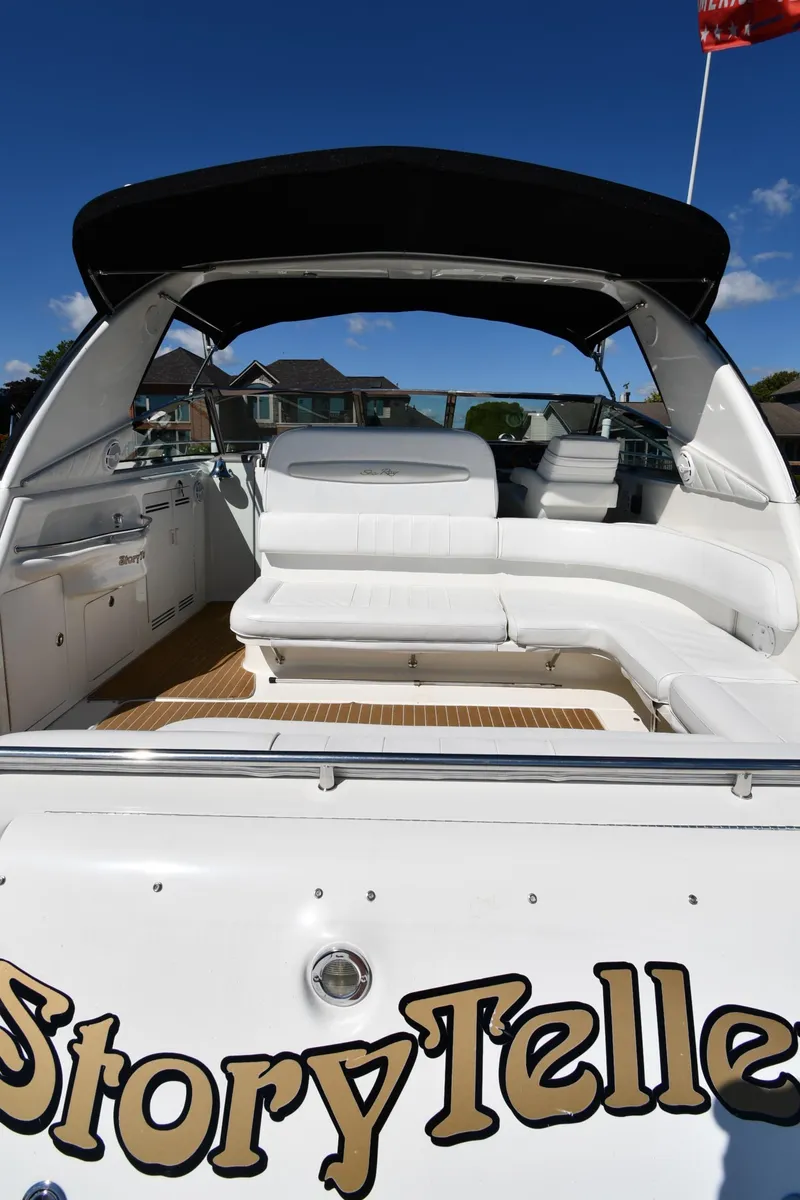 Slide: The Image of 1997 Sea Ray 400 Sundancer boat with spacious seating and canopy, named "StoryTeller." - 8