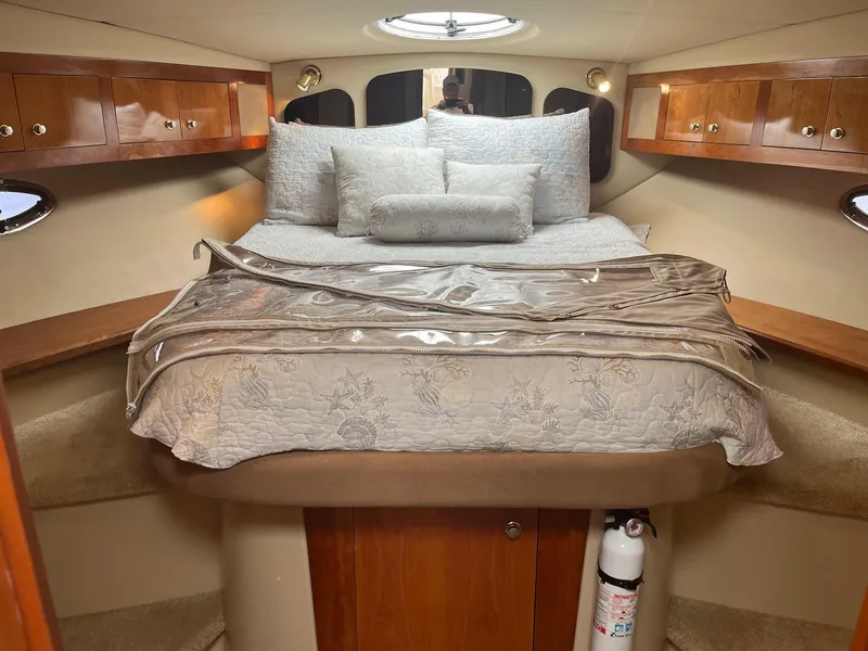 Slide: The Image of Luxurious cabin interior of 2003 Cruisers Yachts 400 Express with cozy bedding. - 13