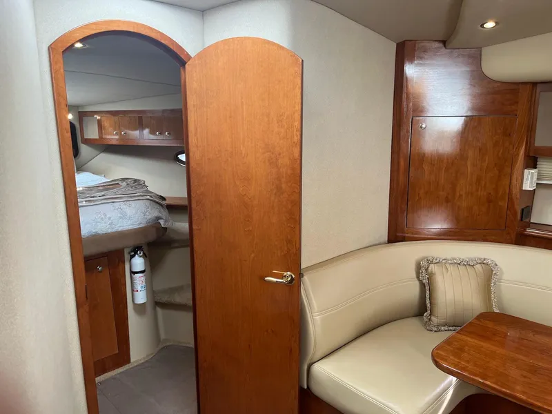 Slide: The Image of 2003 Cruisers Yachts 400 Express interior with wood finish and cozy seating area. - 14
