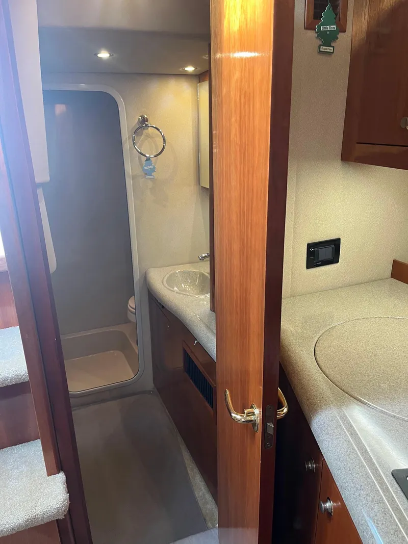 Slide: The Image of 2003 Cruisers Yachts 400 Express bathroom interior with sink and shower. - 15