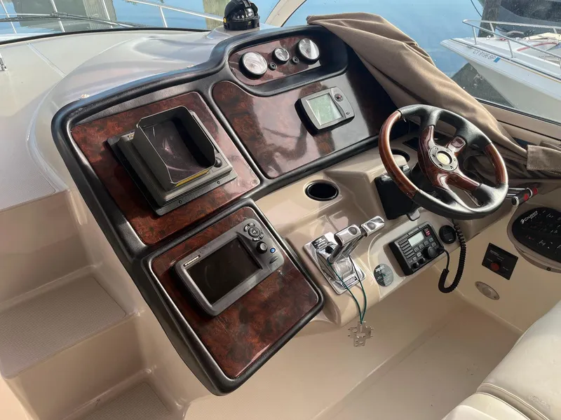 Slide: The Image of Dashboard of 2003 Cruisers Yachts 400 Express with wood accents and navigation equipment. - 3