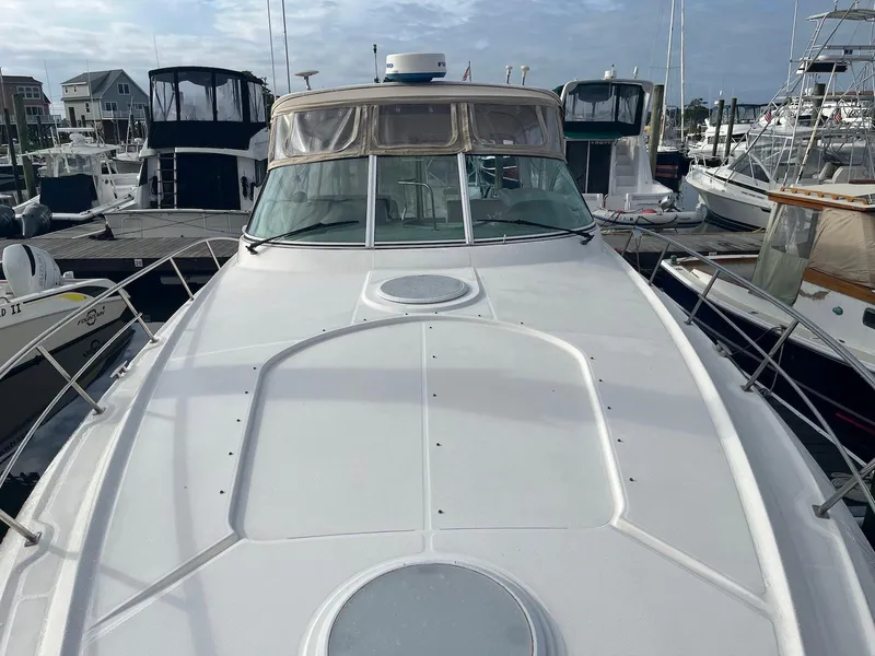 Slide: The Image of 2003 Cruisers Yachts 400 Express docked at marina, front deck view. - 7