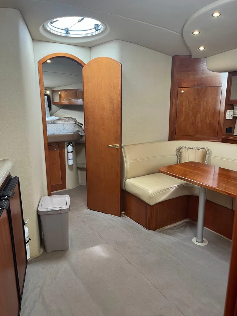 Slide: The Image of Interior of 2003 Cruisers Yachts 400 Express with dining area and cabin view. - 8