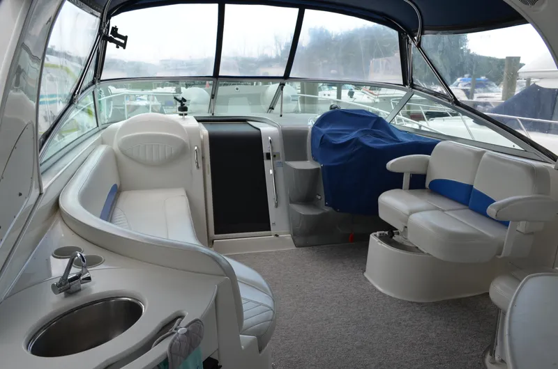 Slide: The Image of 2007 Bayliner 325 Sunbridge interior with seating, sink, and covered helm. - 10