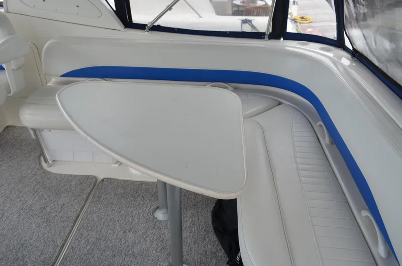 Slide: The Image of 2007 Bayliner 325 Sunbridge interior with white seating and table. - 12