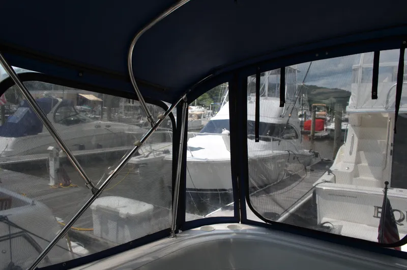 Slide: The Image of 2007 Bayliner 325 Sunbridge interior view at marina, showcasing docked boats. - 16