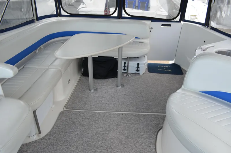 Slide: The Image of 2007 Bayliner 325 Sunbridge interior with seating, table, and carpeted floor. - 18