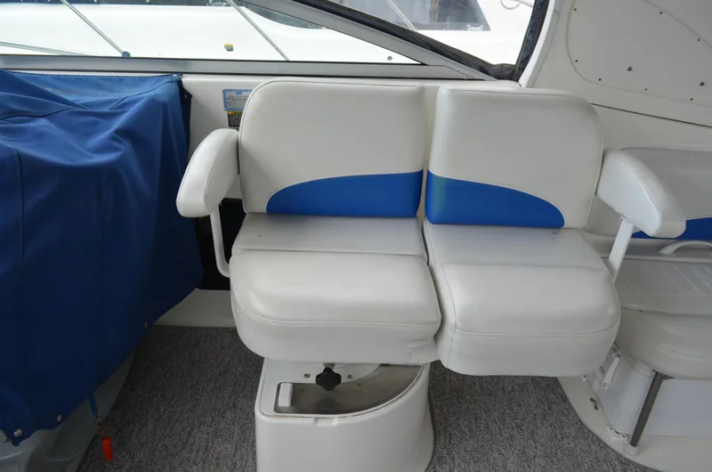 Slide: The Image of 2007 Bayliner 325 Sunbridge boat interior with white and blue seating. - 19