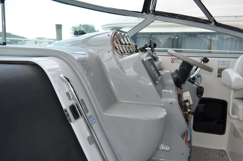 Slide: The Image of 2007 Bayliner 325 Sunbridge helm with steering wheel and control panel. - 21