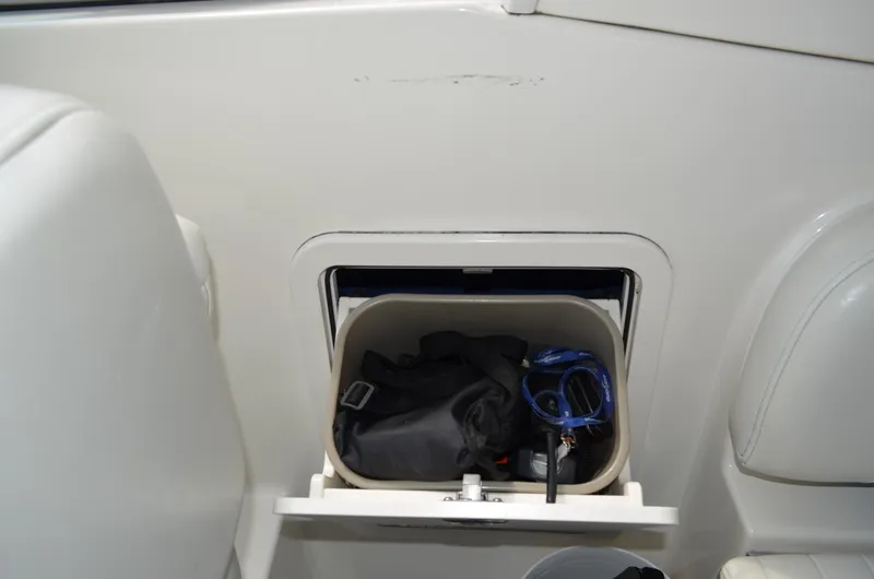 Slide: The Image of Storage compartment on a 2007 Bayliner 325 Sunbridge boat, containing various items. - 22