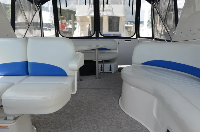 Slide: The Image of 2007 Bayliner 325 Sunbridge interior with white and blue seating, spacious layout. - 23