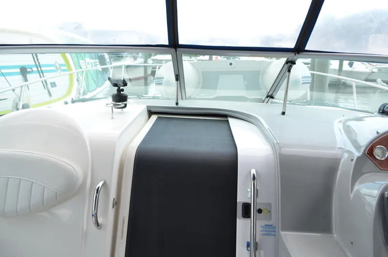 Slide: The Image of 2007 Bayliner 325 Sunbridge cockpit view with windshield and seating area. - 24