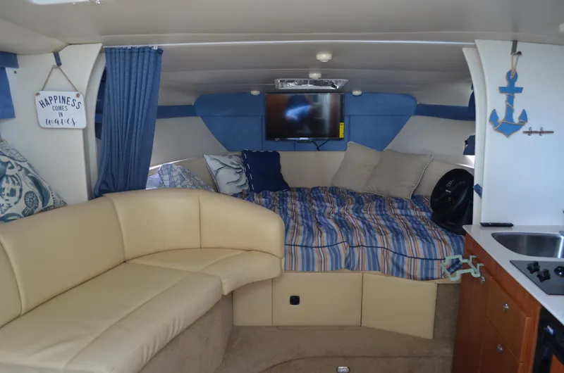 Slide: The Image of Interior of 2007 Bayliner 325 Sunbridge with cozy seating and nautical decor. - 26