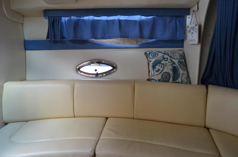 Slide: The Image of Interior of 2007 Bayliner 325 Sunbridge with cream seating and nautical decor. - 29