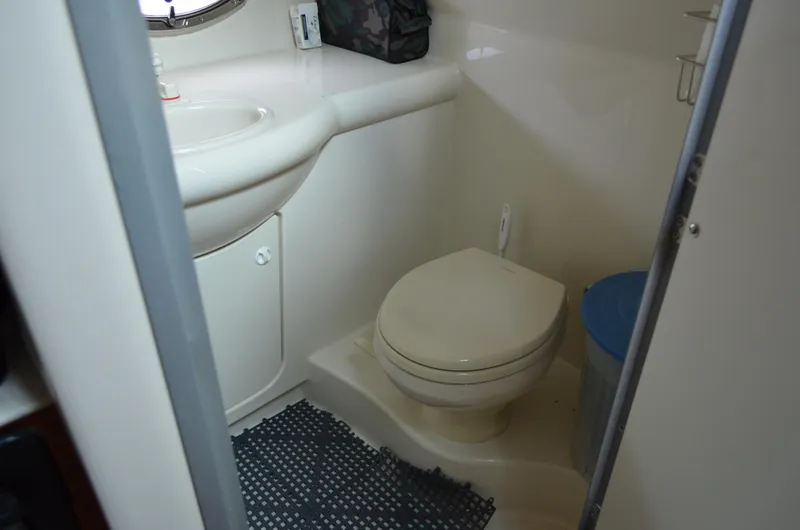 Slide: The Image of Bathroom interior of 2007 Bayliner 325 Sunbridge boat, featuring toilet and sink. - 34