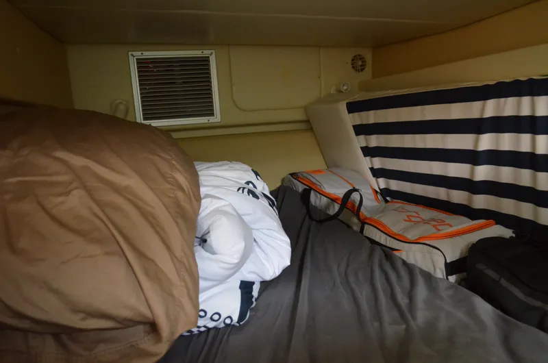 Slide: The Image of Cozy cabin interior of 2007 Bayliner 325 Sunbridge with striped cushions and bedding. - 35