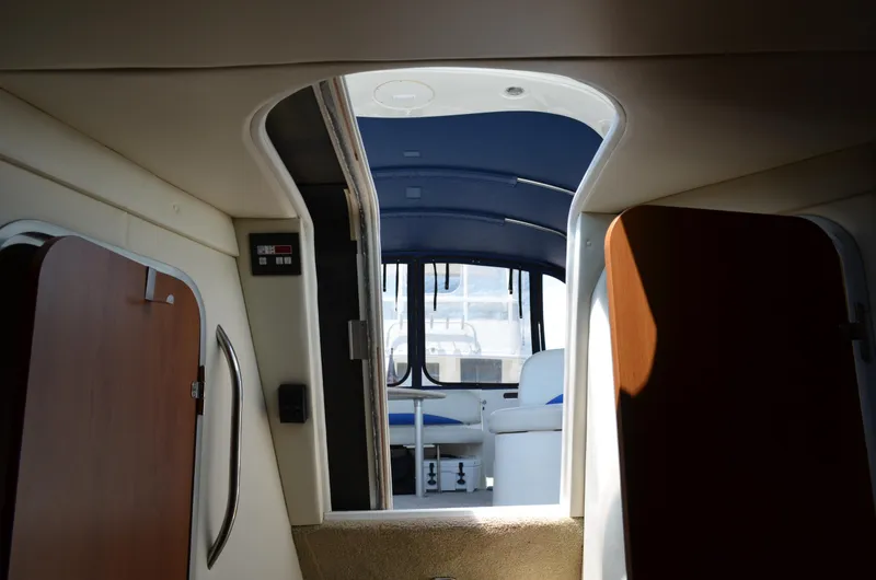 Slide: The Image of Interior view of 2007 Bayliner 325 Sunbridge cabin with seating and open doors. - 38