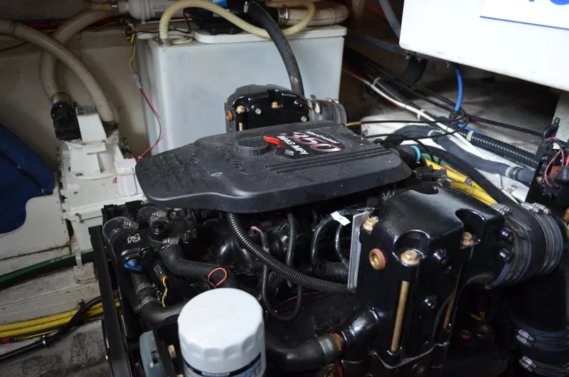 Slide: The Image of Engine compartment of a 2007 Bayliner 325 Sunbridge boat, showcasing mechanical components. - 42