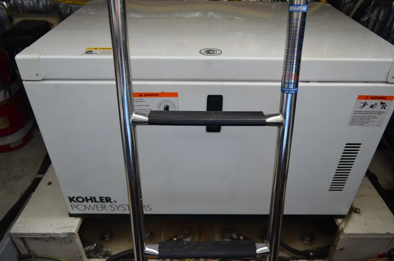 Slide: The Image of Kohler power system in 2007 Bayliner 325 Sunbridge engine room, with ladder access. - 43