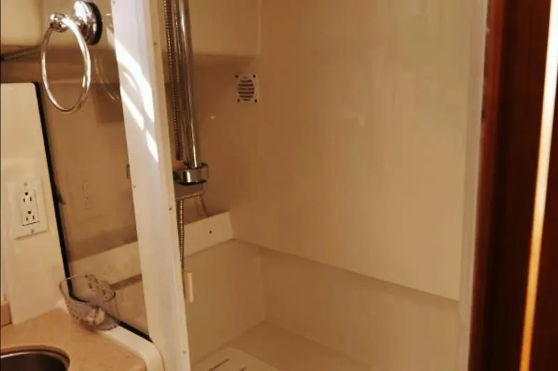 Slide: The Image of Interior of 2007 Back Cove 33 yacht with beige seating and wooden cabinetry. - 13