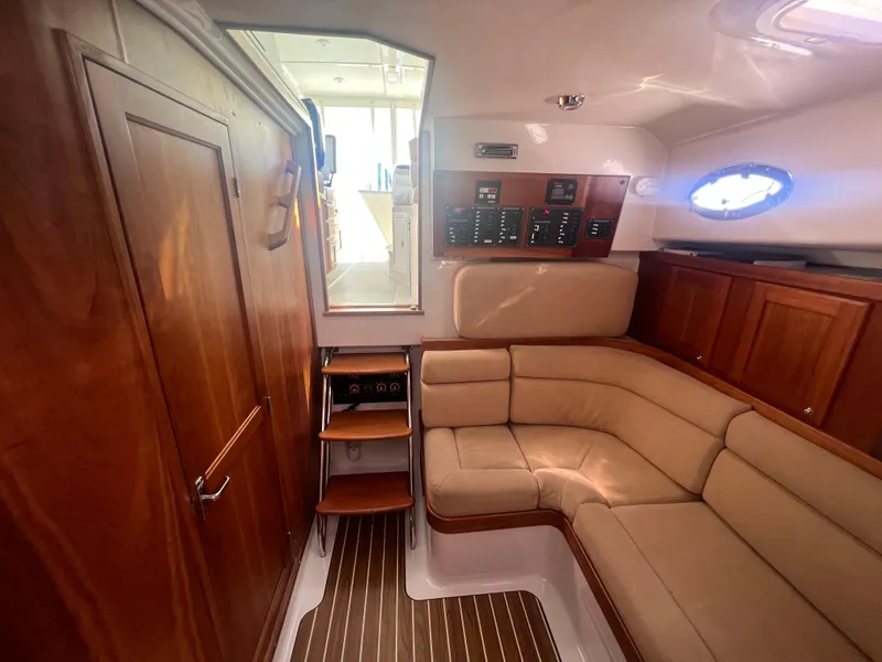 Slide: The Image of Interior of a 2007 Back Cove 33 yacht with seating and table, overlooking the water. - 19