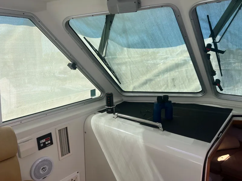 Slide: The Image of Helm of 2007 Back Cove 33 boat with Garmin navigation system and wooden steering wheel. - 6