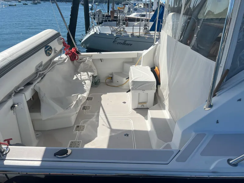 Slide: The Image of Interior of a 2007 Back Cove 33 boat with beige seating and large windows. - 9