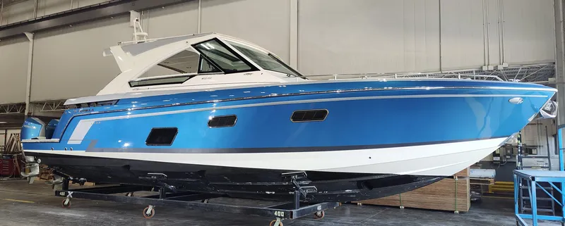 Slide: The Image of 2019 Formula 400 Super Sport Crossover boat in a warehouse setting. - 1