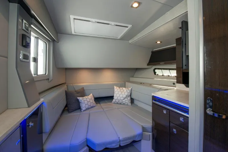 Slide: The Image of Interior of 2019 Formula 400 Super Sport Crossover yacht, featuring modern seating and ambient lighting. - 13