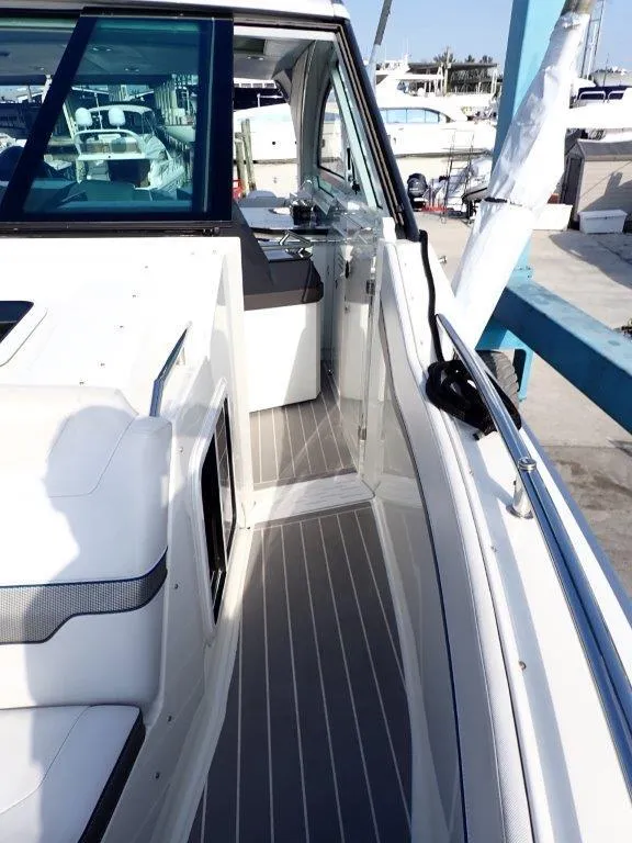 Slide: The Image of 2019 Formula 400 Super Sport Crossover yacht, sleek white deck, docked at marina. - 22