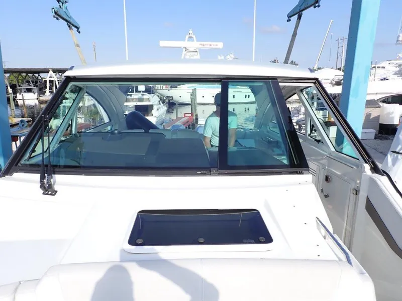 Slide: The Image of 2019 Formula 400 Super Sport Crossover boat docked at marina. - 23