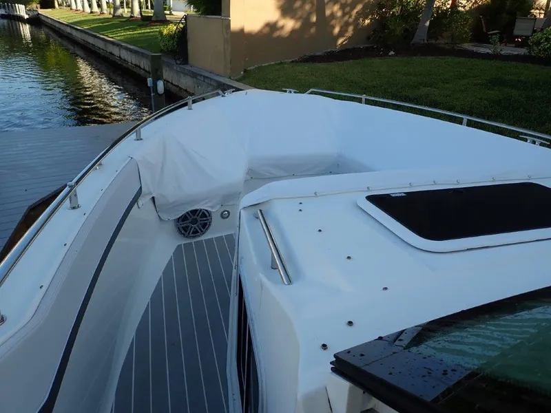 Slide: The Image of 2019 Formula 400 Super Sport Crossover boat docked by a canal. - 25