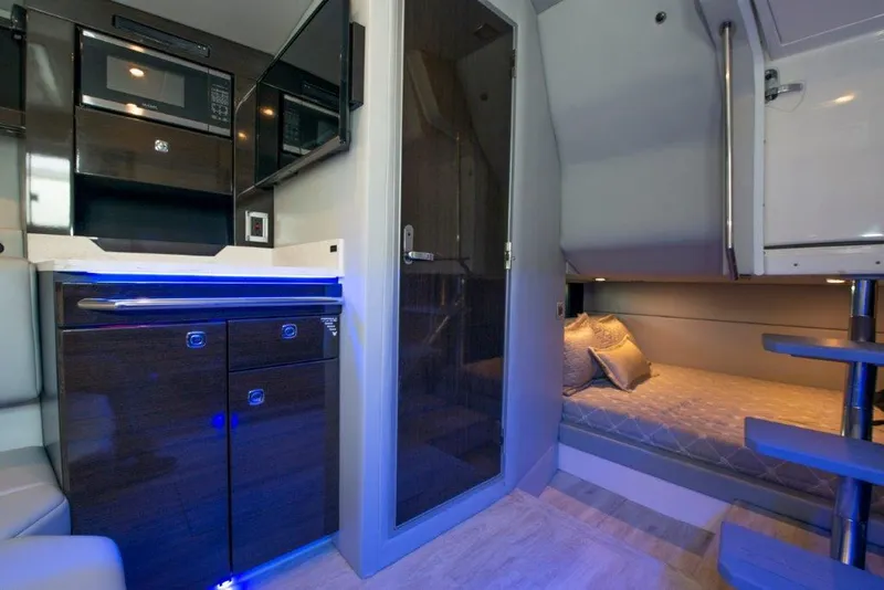 Slide: The Image of Interior of 2019 Formula 400 Super Sport Crossover, featuring modern kitchen and cozy sleeping area. - 9