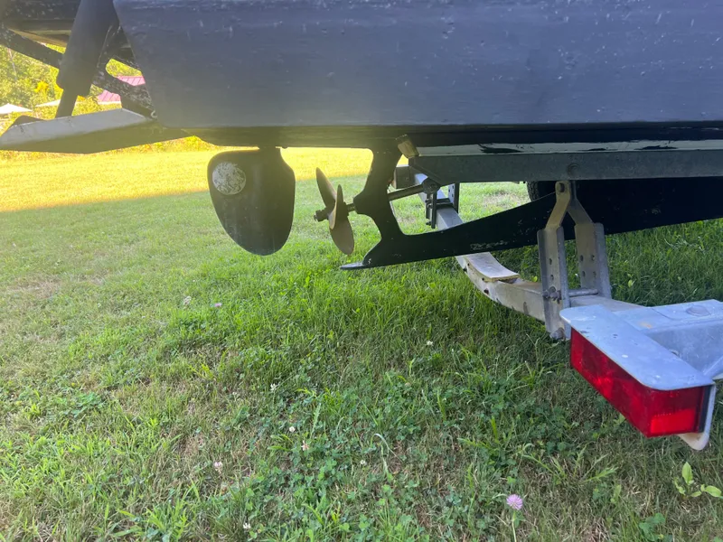 Slide: The Image of 1988 Shamrock 20 Cuddy boat on trailer, showing propeller and rudder. - 3