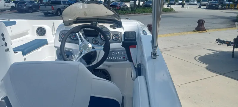 Slide: The Image of 2024 Tahoe 2150 boat interior with steering wheel and dashboard controls. - 2