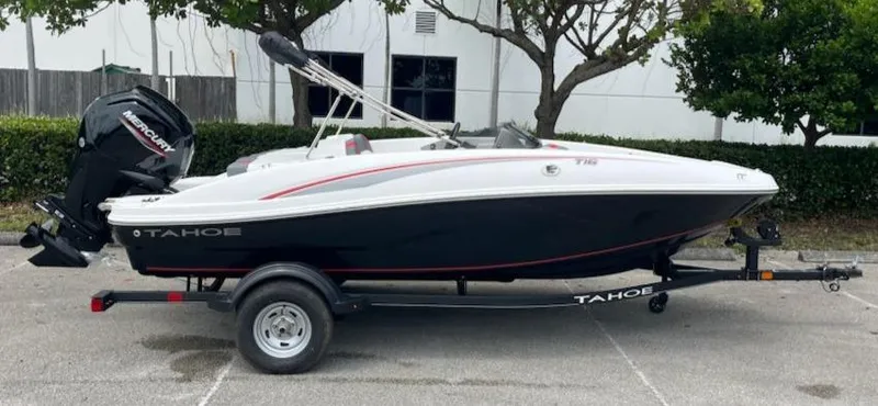 Slide: The Image of 2024 Tahoe T16 boat on trailer, parked outdoors. - 1