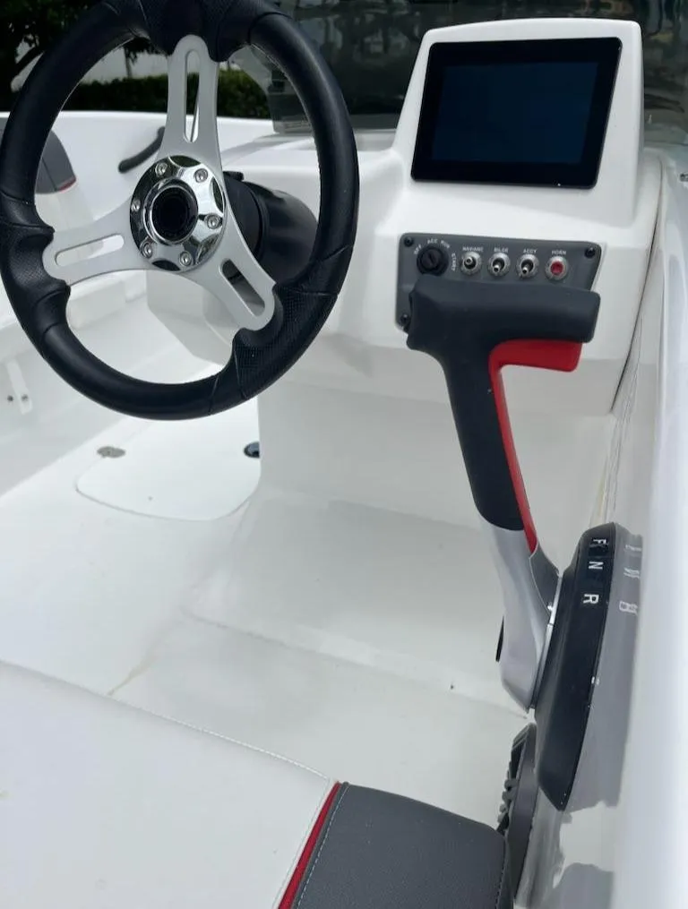 Slide: The Image of 2024 Tahoe T16 boat cockpit with steering wheel and control panel. - 4