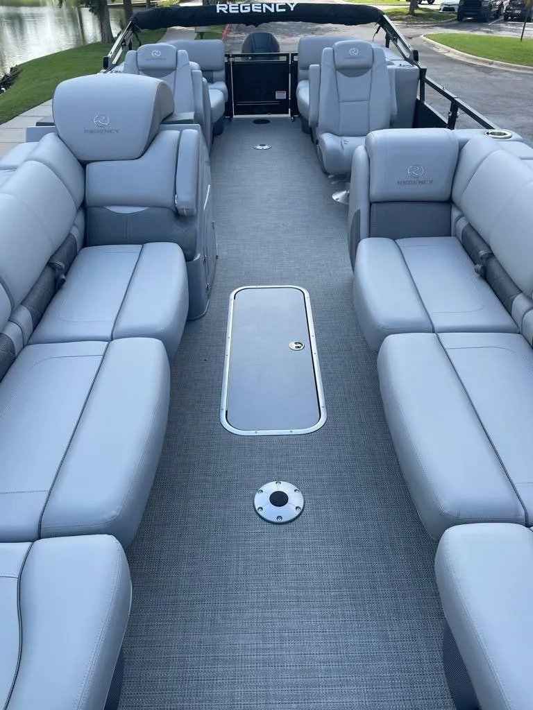 Slide: The Image of Luxurious 2024 Regency 250 LE3 pontoon boat with spacious seating and sleek design. - 3