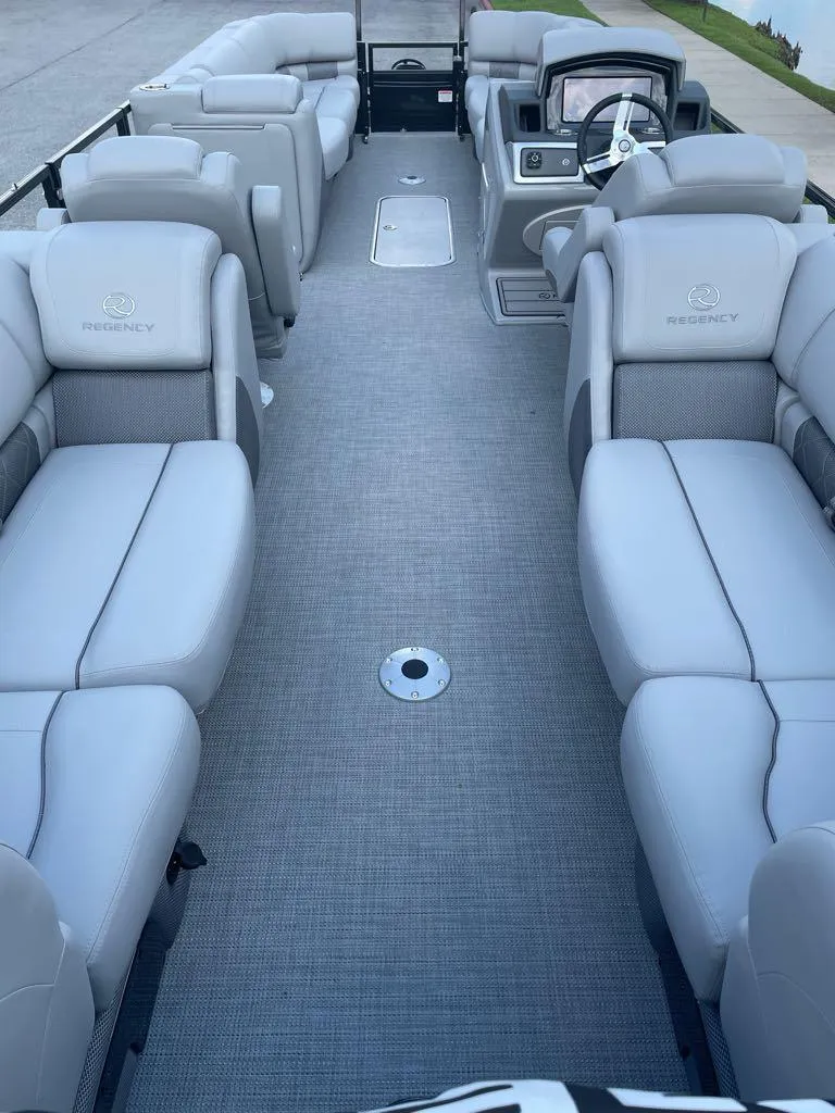 Slide: The Image of 2024 Regency 250 LE3 pontoon boat with spacious seating and modern interior design. - 4