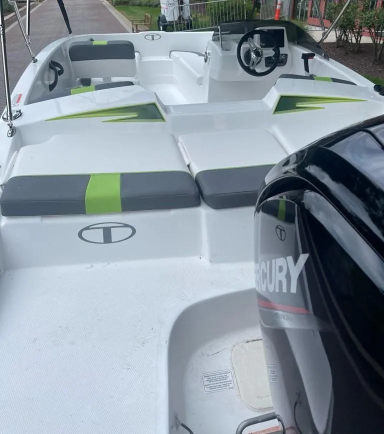 Slide: The Image of 2024 Tahoe T16 boat with Mercury engine, featuring sleek design and green accents. - 2
