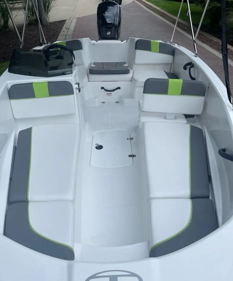 Slide: The Image of 2024 Tahoe T16 boat interior with gray and green seating, sleek design. - 3