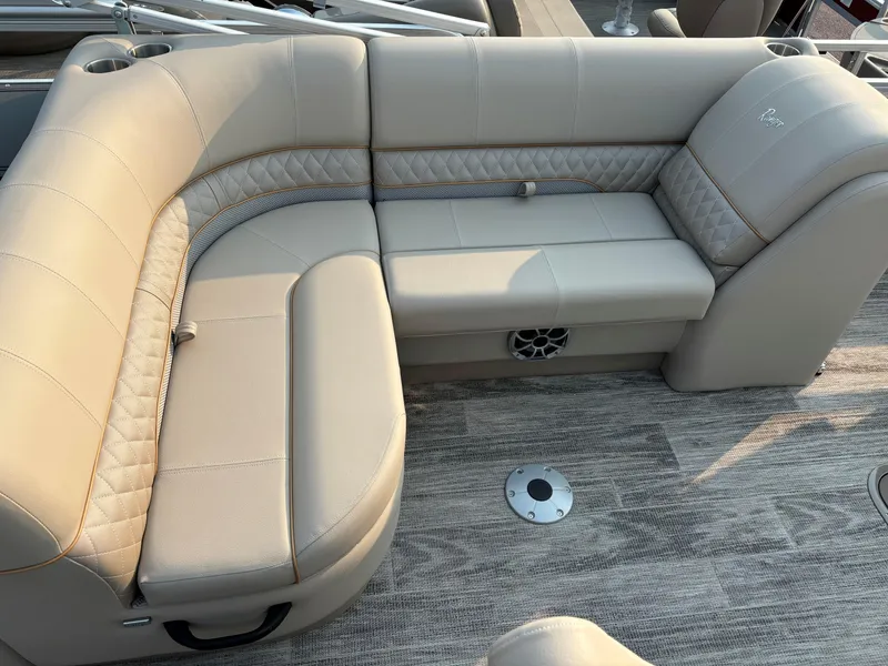 Slide: The Image of 2024 Ranger Reata 223FC boat interior with beige cushioned seating and textured flooring. - 10