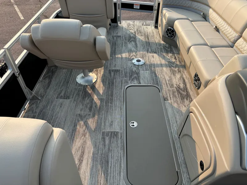 Slide: The Image of 2024 Ranger Reata 223FC interior with beige seating and modern flooring. - 11