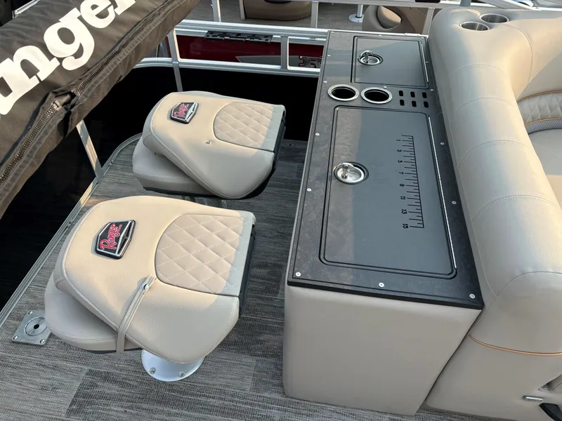 Slide: The Image of 2024 Ranger Reata 223FC boat interior with cushioned seats and fishing station. - 13