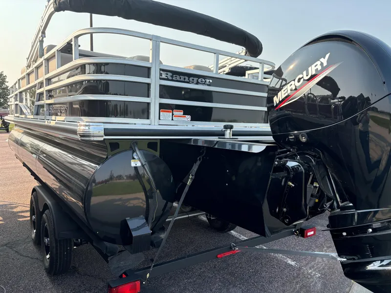 Slide: The Image of 2024 Ranger Reata 223FC pontoon boat with Mercury outboard engine on trailer. - 2