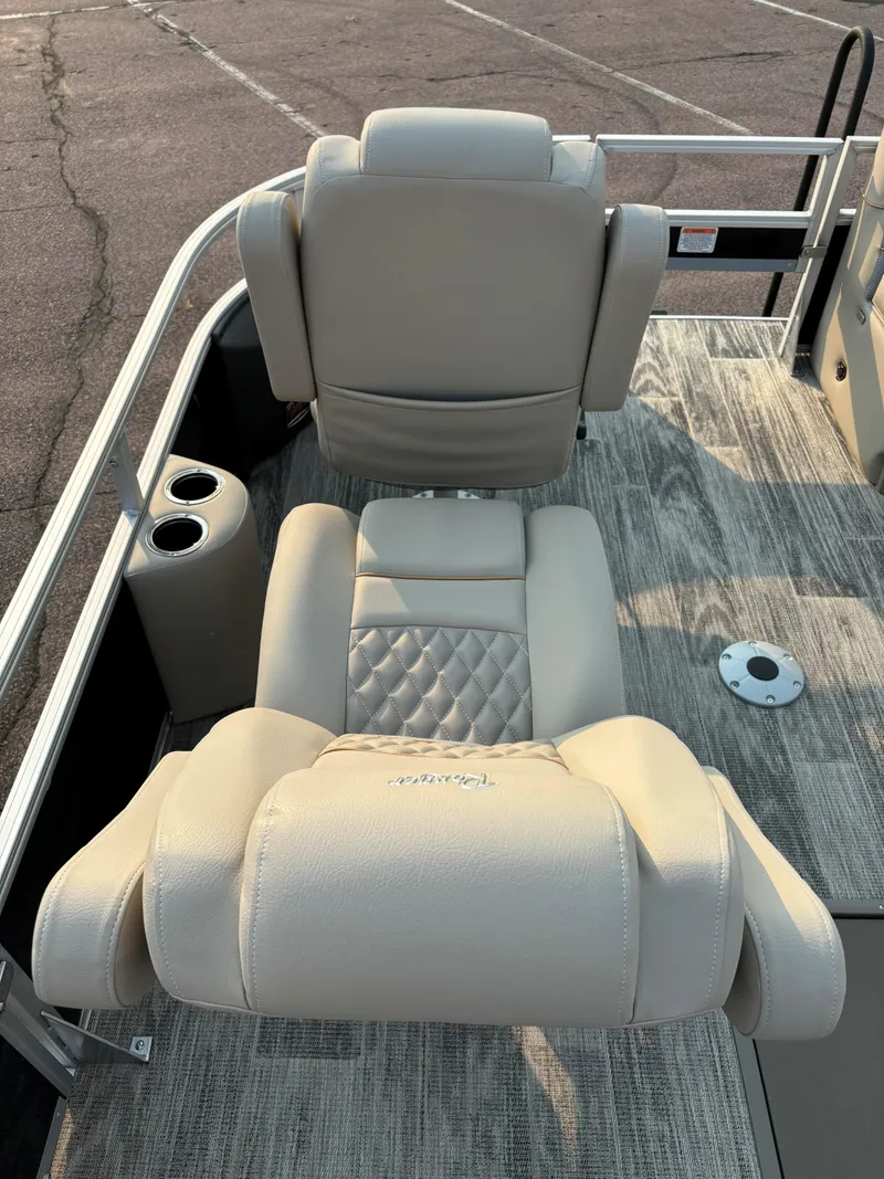 Slide: The Image of 2024 Ranger Reata 223FC boat interior with beige seating and cup holders. - 9